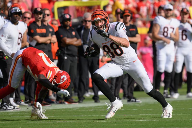 Cincinnati Bengals tight end Mike Gesicki (88) runs after a catch as Kansas City Chiefs safety Chamarri Conner, left, falls down during the first half of an NFL football game, Sunday, Sept. 15, 2024 in Kansas City, Mo. (AP Photo/Reed Hoffmann)