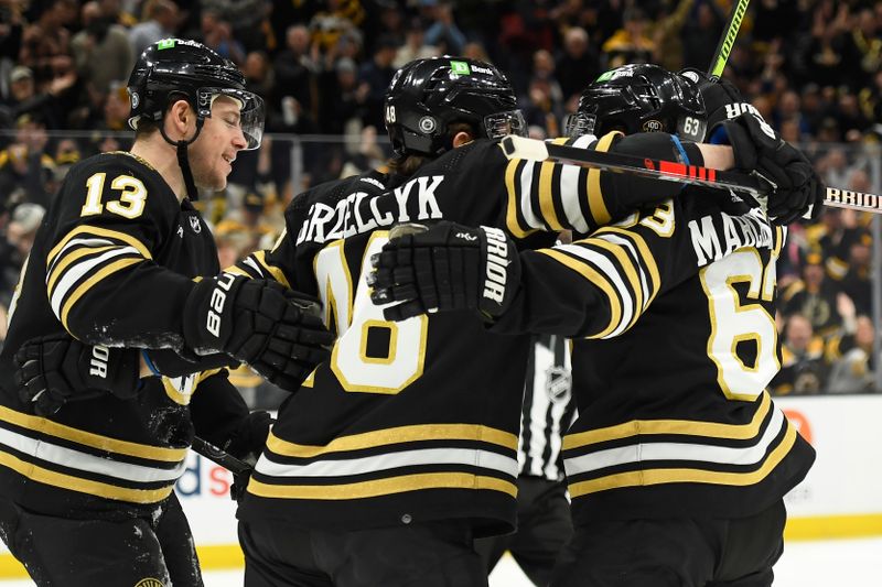 Jan 4, 2024; Boston, Massachusetts, USA; Boston Bruins center Charlie Coyle (13) and defenseman Matt Grzelcyk (48) celebrates a goal by left wing Brad Marchand (63) during the first period against the Pittsburgh Penguins at TD Garden. Mandatory Credit: Bob DeChiara-USA TODAY Sports