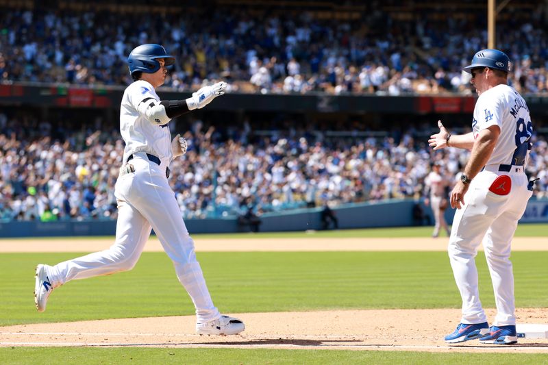 May 5, 2024; Los Angeles, California, USA;  Los Angeles Dodgers designated hitter Shohei Ohtani (17) is greeted by first base coach Clayton McCullough (86) after hitting a home run during the eighth inning against the Atlanta Braves at Dodger Stadium. Mandatory Credit: Kiyoshi Mio-USA TODAY Sports