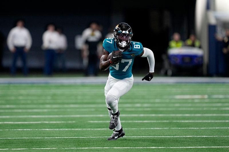 Jacksonville Jaguars wide receiver Jaray Jenkins gains yards after catching a pass during a presesaon NFL football game against the Dallas Cowboys in Arlington, Texas, Saturday, Aug. 12, 2022. (AP Photo/Tony Gutierrez)