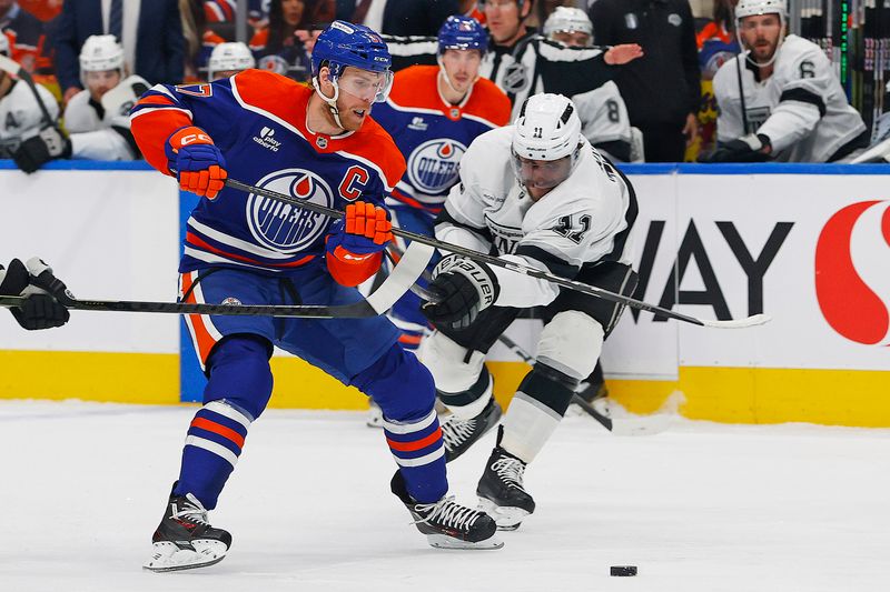 May 1, 2025; Edmonton, Alberta, CAN; Los Angeles Kings forward Anze Kopitar (11) tries to knock the puck away from Edmonton Oilers forward Connor McDavid (97) during the first periodin game six of the first round of the 2025 Stanley Cup Playoffs at Rogers Place. Mandatory Credit: Perry Nelson-Imagn Images