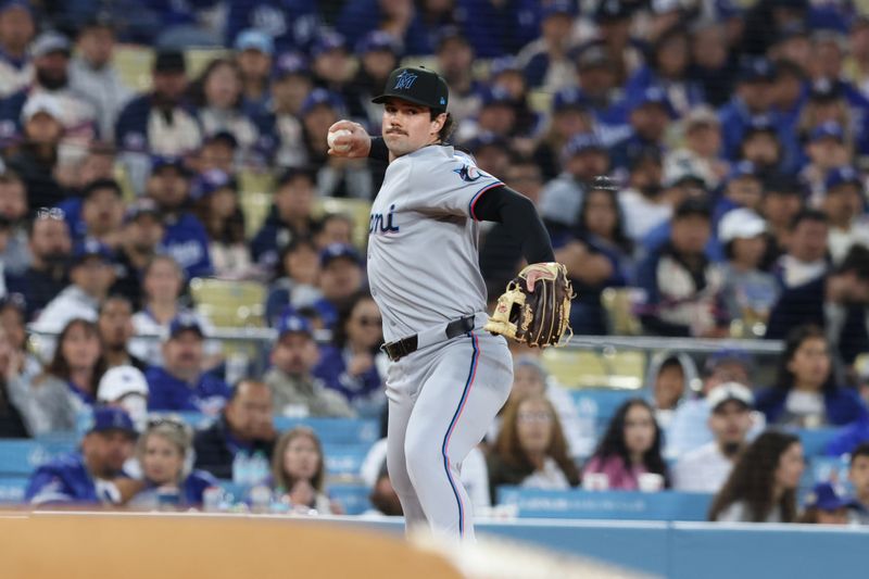 Apr 28, 2025; Los Angeles, California, USA;  Miami Marlins third base Graham Pauley (21) throws to first for an out against the Los Angeles Dodgers during the second inning at Dodger Stadium. Mandatory Credit: Jason Parkhurst-Imagn Images