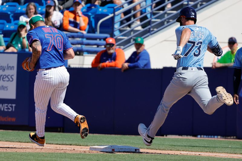 Mar 17, 2025; Port St. Lucie, Florida, USA;  New York Mets pitcher Jose Butto (70) covers the first base in time on an infield hit to get out Tampa Bay Rays outfielder Tristan Peters during the eighth inning at Clover Park. Mandatory Credit: Reinhold Matay-Imagn Images. 