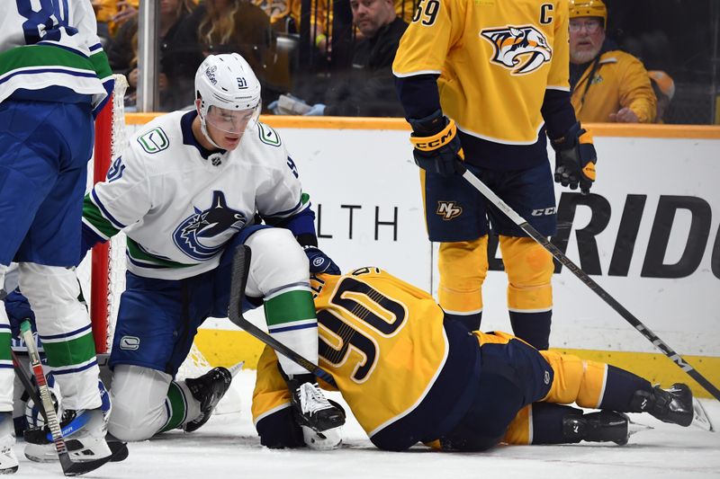 Dec 19, 2023; Nashville, Tennessee, USA; Vancouver Canucks defenseman Nikita Zadorov (91) pulls down Nashville Predators center Ryan O'Reilly (90) after the whistle during the third period at Bridgestone Arena. Mandatory Credit: Christopher Hanewinckel-USA TODAY Sports