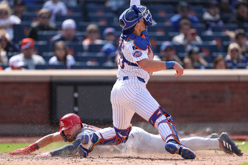 Apr 20, 2025; New York City, New York, USA; St. Louis Cardinals pinch runner Michael Siani (22) scores a run behind New York Mets catcher Hayden Senger (30) during the seventh inning at Citi Field. Mandatory Credit: Vincent Carchietta-Imagn Images