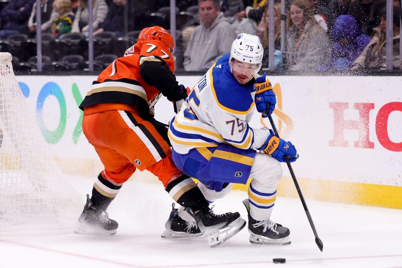 Nov 22, 2024; Anaheim, California, USA; Buffalo Sabres defenseman Connor Clifton (75) moves the puck against Anaheim Ducks right wing Frank Vatrano (77) during the third period at Honda Center. Mandatory Credit: Ryan Sun-Imagn Images