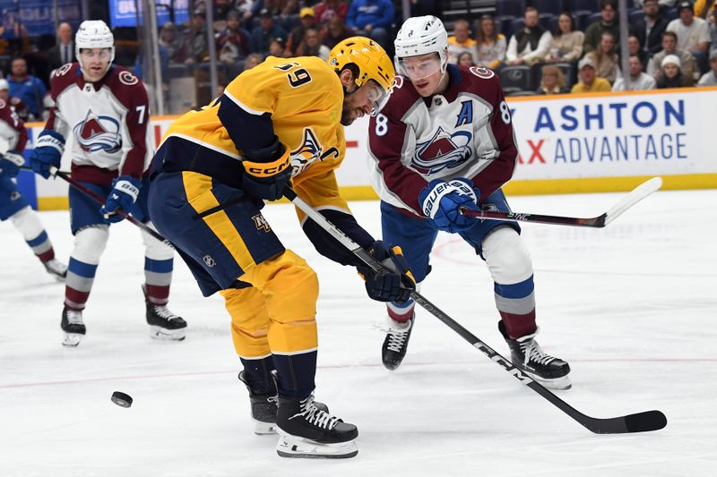 Mar 2, 2024; Nashville, Tennessee, USA; Nashville Predators defenseman Roman Josi (59) has the puck knocked off his stick by Colorado Avalanche defenseman Cale Makar (8) during the first half at Bridgestone Arena. Mandatory Credit: Christopher Hanewinckel-USA TODAY Sports