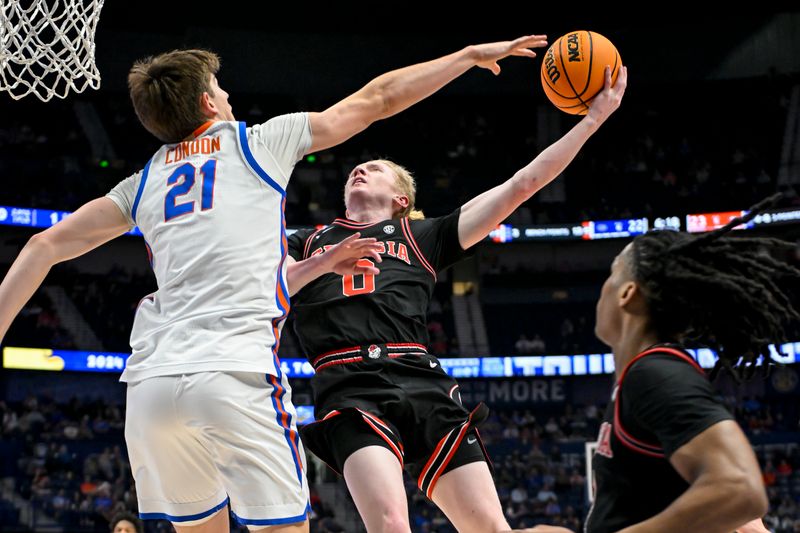 Mar 14, 2024; Nashville, TN, USA;  Georgia Bulldogs guard Blue Cain (0) shoots over Florida Gators forward Alex Condon (21) during the first half at Bridgestone Arena. Mandatory Credit: Steve Roberts-USA TODAY Sports