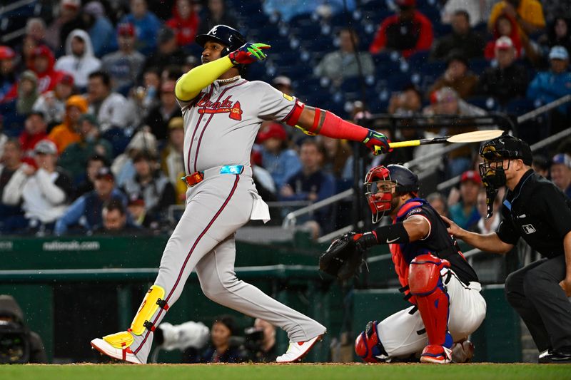 May 22, 2025; Washington, District of Columbia, USA; Atlanta Braves designated hitter Marcell Ozuna (20) singles against the Washington Nationals during the fifth inning at Nationals Park. Mandatory Credit: Brad Mills-Imagn Images
