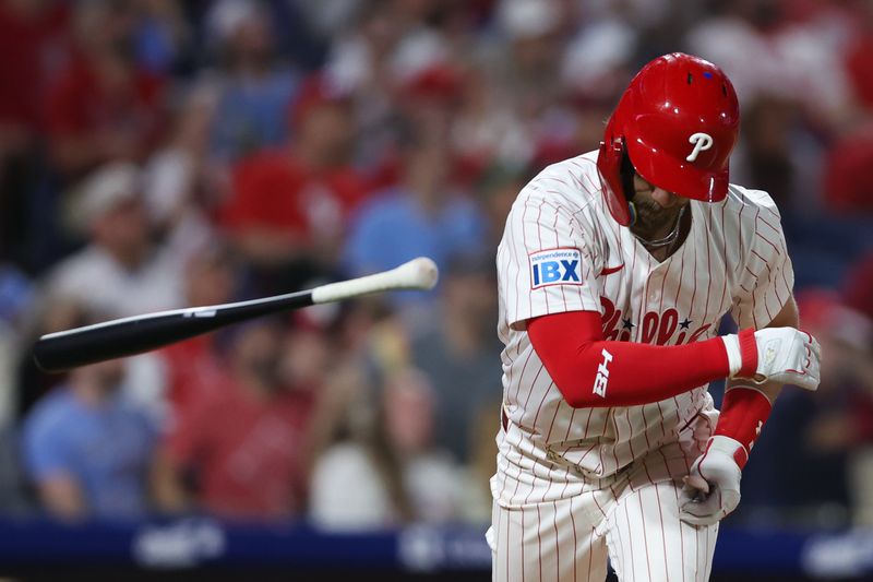 Apr 30, 2025; Philadelphia, Pennsylvania, USA; Philadelphia Phillies first base Bryce Harper (3) tosses his bat after hitting a pop out during the seventh inning against the Washington Nationals at Citizens Bank Park. Mandatory Credit: Bill Streicher-Imagn Images