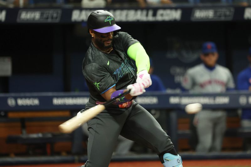 May 3, 2024; St. Petersburg, Florida, USA; Tampa Bay Rays first base Yandy Díaz (2) hits a RBI single against the New York Mets during the second inning at Tropicana Field. Mandatory Credit: Kim Klement Neitzel-USA TODAY Sports