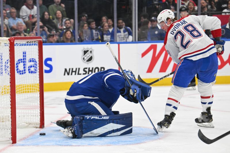 Sep 26, 2024; Toronto, Ontario, CAN;  Montreal Canadiens forward Christian Dvorak (28) scores a goal past Toronto Maple Leafs goalie Anthony Stolarz (41) in the second period at Scotiabank Arena. Mandatory Credit: Dan Hamilton-Imagn Images