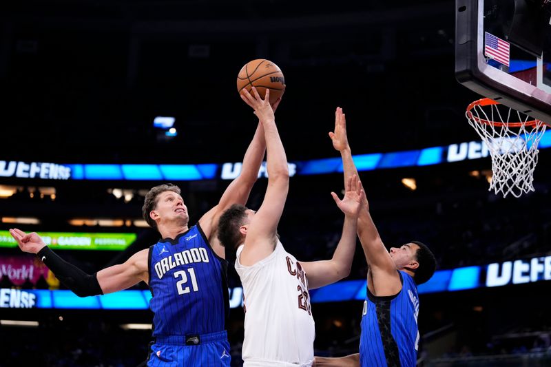 ORLANDO, FLORIDA - APRIL 25: Moritz Wagner #21 of the Orlando Magic blocks the shot of Georges Niang #20 of the Cleveland Cavaliers during the fourth quarter of game three of the Eastern Conference First Round Playoffs at Kia Center on April 25, 2024 in Orlando, Florida. NOTE TO USER: User expressly acknowledges and agrees that, by downloading and or using this photograph, User is consenting to the terms and conditions of the Getty Images License Agreement. (Photo by Rich Storry/Getty Images)