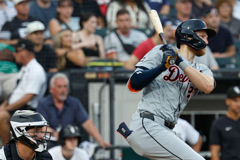 Aug 24, 2024; Chicago, Illinois, USA; Detroit Tigers outfielder Parker Meadows (22) hits an RBI-single against the Chicago White Sox during the third inning at Guaranteed Rate Field. Mandatory Credit: Kamil Krzaczynski-USA TODAY Sports