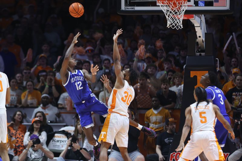 Mar 9, 2024; Knoxville, Tennessee, USA; Kentucky Wildcats guard Antonio Reeves (12) shoots the ball against Tennessee Volunteers guard Josiah-Jordan James (30) during the second half at Thompson-Boling Arena at Food City Center. Mandatory Credit: Randy Sartin-USA TODAY Sports