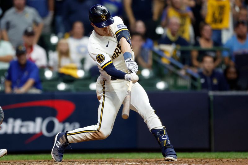 Oct 4, 2023; Milwaukee, Wisconsin, USA; Milwaukee Brewers player Mark Canha (21) hits a single in eighth inning against the Arizona Diamondbacks during game two of the Wildcard series for the 2023 MLB playoffs at American Family Field. Mandatory Credit: Kamil Krzaczynski-USA TODAY Sports