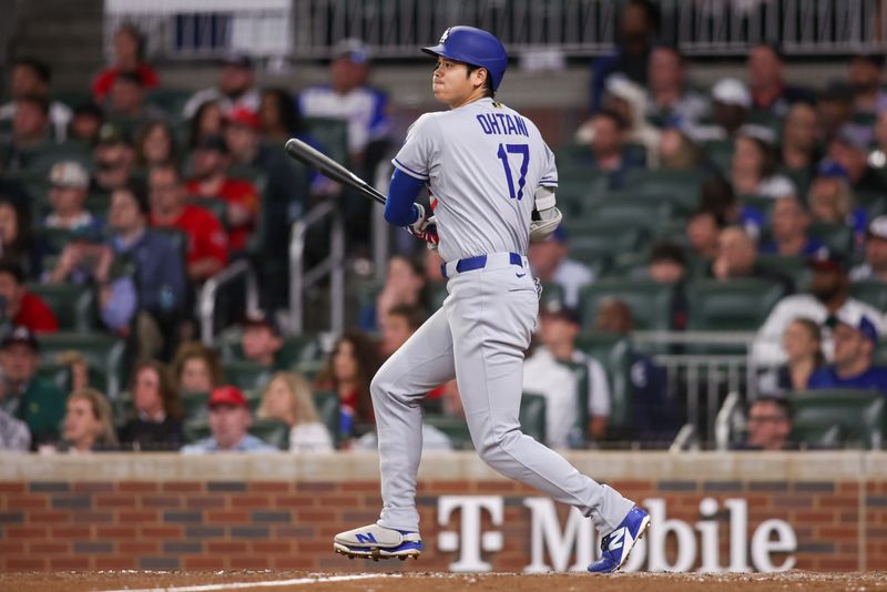 May 4, 2025; Atlanta, Georgia, USA; Los Angeles Dodgers designated hitter Shohei Ohtani (17) hits a double against the Atlanta Braves in the seventh inning at Truist Park. Mandatory Credit: Brett Davis-Imagn Images