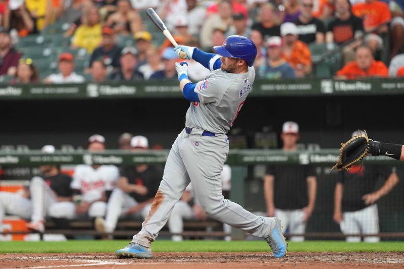 Jul 9, 2024; Baltimore, Maryland, USA; Chicago Cubs outfielder Ian Happ (8) connects on a three run home run in the fourth inning against the Baltimore Orioles at Oriole Park at Camden Yards. Mandatory Credit: Mitch Stringer-USA TODAY Sports
