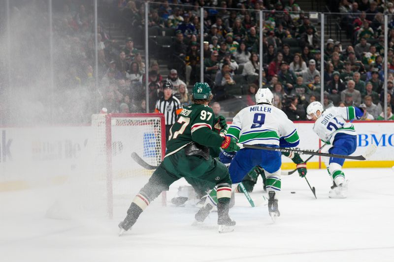 Feb 19, 2024; Saint Paul, Minnesota, USA; Vancouver Canucks left wing Nils Hoglander (21) passes to center J.T. Miller (9) who would score against the Minnesota Wild in the first period at Xcel Energy Center. Mandatory Credit: Matt Blewett-USA TODAY Sports