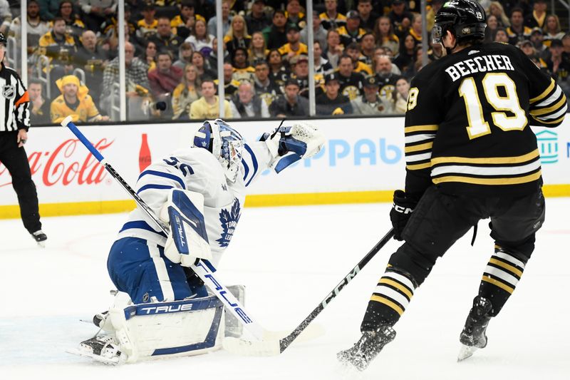 May 4, 2024; Boston, Massachusetts, USA; Toronto Maple Leafs goaltender Ilya Samsonov (35) deflects the puck with his glove in front of Boston Bruins center John Beecher (19) during the first period in game seven of the first round of the 2024 Stanley Cup Playoffs at TD Garden. Mandatory Credit: Bob DeChiara-USA TODAY Sports