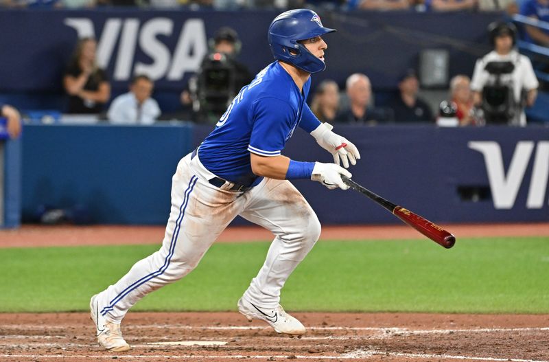 Aug 26, 2023; Toronto, Ontario, CAN;  Toronto Blue Jays center fielder Daulton Varsho (25) hits a two RBI single against the Cleveland Guardians in the seventh inning at Rogers Centre. Mandatory Credit: Dan Hamilton-USA TODAY Sports