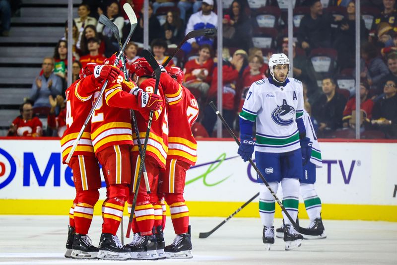 Sep 28, 2024; Calgary, Alberta, CAN; Calgary Flames defenseman Brayden Pachal (94) celebrates his goal with teammates against the Vancouver Canucks during the first period at Scotiabank Saddledome. Mandatory Credit: Sergei Belski-Imagn Images