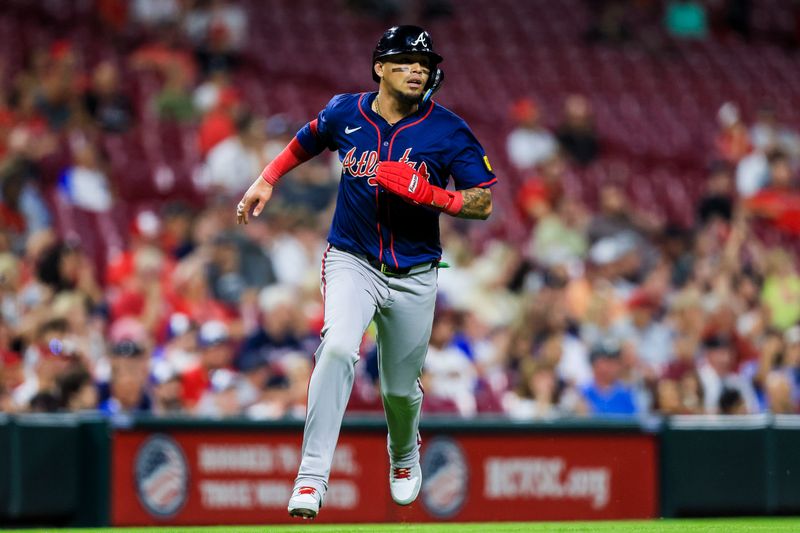 Sep 18, 2024; Cincinnati, Ohio, USA; Atlanta Braves shortstop Orlando Arcia (11) scores on a RBI double hit by third baseman Gio Urshela (not pictured) in the ninth inning against the Cincinnati Reds at Great American Ball Park. Mandatory Credit: Katie Stratman-Imagn Images