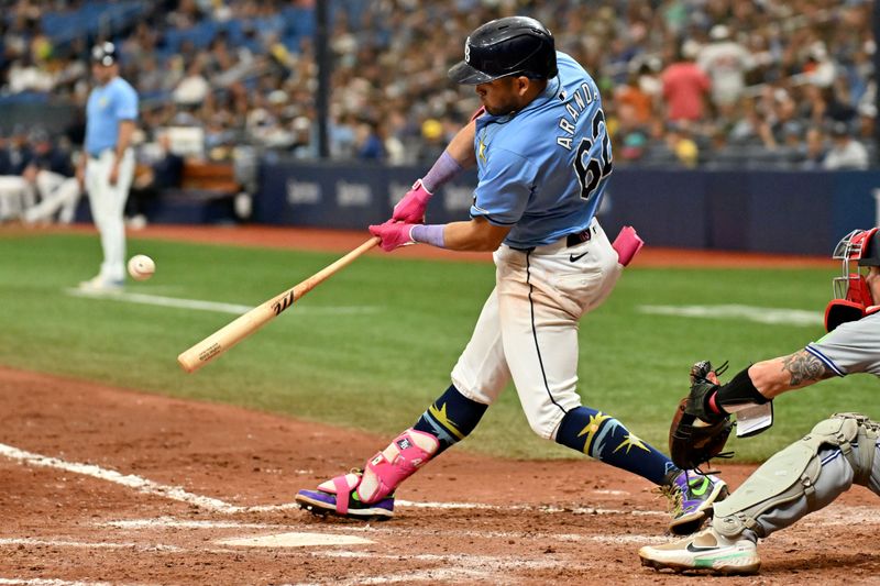 Sep 22, 2024; St. Petersburg, Florida, USA; Tampa Bay Rays first baseman Jonathan Aranda (62) hits a two run home run in the sixth inning against the Toronto Blue Jays at Tropicana Field. Mandatory Credit: Jonathan Dyer-Imagn Images