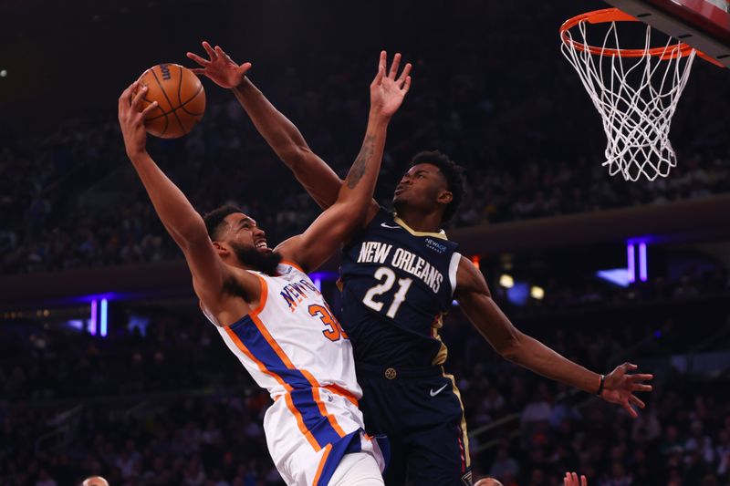 NEW YORK, NEW YORK - DECEMBER 01: Karl-Anthony Towns #32 of the New York Knicks drives to the net against Yves Missi #21 of the New Orleans Pelicans during the first half at Madison Square Garden on December 01, 2024 in New York City. NOTE TO USER: User expressly acknowledges and agrees that, by downloading and or using this Photograph, user is consenting to the terms and conditions of the Getty Images License Agreement. Mandatory Copyright Notice: Copyright 2024 NBAE (Photo by Mike Stobe/Getty Images)