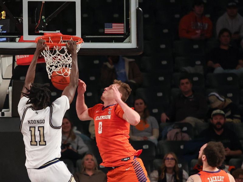 Jan 14, 2025; Atlanta, Georgia, USA; Georgia Tech Yellow Jackets forward Baye Ndongo (11) dunks the ball against Clemson Tigers center Viktor Lakhin (0) during the second half at McCamish Pavilion. Mandatory Credit: Jordan Godfree-Imagn Images