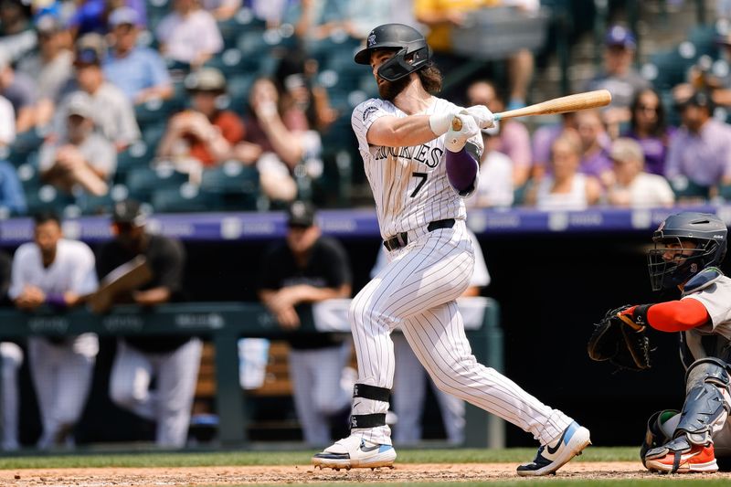 Jul 24, 2024; Denver, Colorado, USA;Colorado Rockies second baseman Brendan Rodgers (7) hits a single in the fourth inning against the Boston Red Sox  at Coors Field. Mandatory Credit: Isaiah J. Downing-USA TODAY Sports