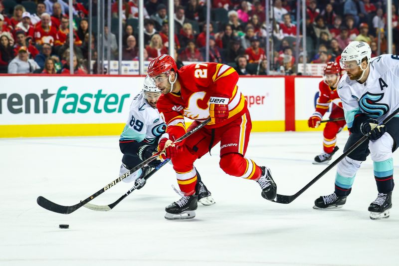 Jan 5, 2026; Calgary, Alberta, CAN; Calgary Flames right wing Matt Coronato (27) controls the puck against the Seattle Kraken during the second period at Scotiabank Saddledome. Mandatory Credit: Sergei Belski-Imagn Images