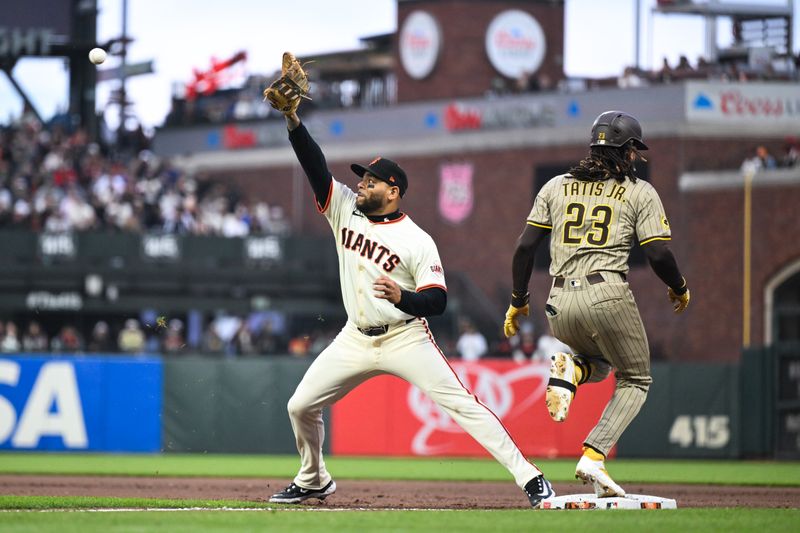 Jun 4, 2025; San Francisco, California, USA; San Diego Padres right fielder Fernando Tatis Jr. (23) runs to first base  against San Francisco Giants first baseman Dominic Smith (7) in the fifth inning at Oracle Park. Mandatory Credit: Eakin Howard-Imagn Images