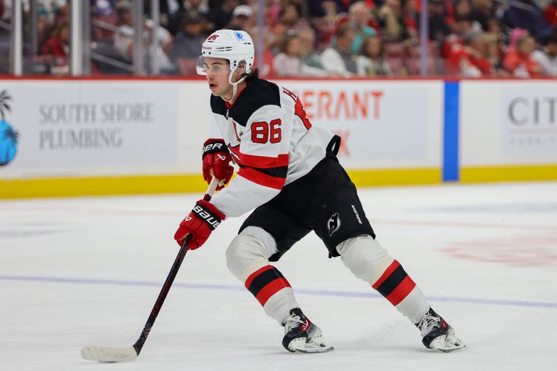 Nov 12, 2024; Sunrise, Florida, USA; New Jersey Devils center Jack Hughes (86) moves the puck against the Florida Panthers during the first period at Amerant Bank Arena. Mandatory Credit: Sam Navarro-Imagn Images