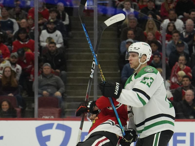 Nov 27, 2024; Chicago, Illinois, USA; Dallas Stars defenseman Esa Lindell (23) and Chicago Blackhawks center Jason Dickinson (16) go for the puck during the first period at United Center. Mandatory Credit: David Banks-Imagn Images