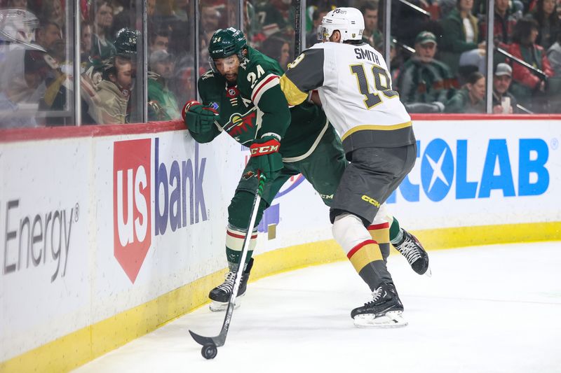 Apr 3, 2023; Saint Paul, Minnesota, USA; Vegas Golden Knights right wing Reilly Smith (19) checks Minnesota Wild defenseman Matt Dumba (24) during the first period at Xcel Energy Center. Mandatory Credit: Matt Krohn-USA TODAY Sports