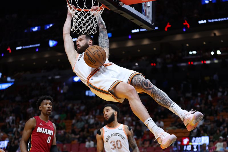 MIAMI, FLORIDA - FEBRUARY 07: Sandro Mamukelashvili #54 of the San Antonio Spurs dunks the ball against the Miami Heat during the fourth quarter of the game at Kaseya Center on February 07, 2024 in Miami, Florida. NOTE TO USER: User expressly acknowledges and agrees that, by downloading and or using this photograph, User is consenting to the terms and conditions of the Getty Images License Agreement. (Photo by Megan Briggs/Getty Images)