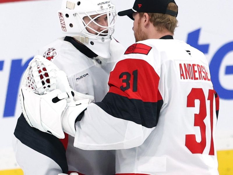 Nov 21, 2025; Winnipeg, Manitoba, CAN; Carolina Hurricanes goaltender Brandon Bussi (32) and goaltender Frederik Andersen (31) celebrate their victory over the Winnipeg Jets at Canada Life Centre. Mandatory Credit: James Carey Lauder-Imagn Images