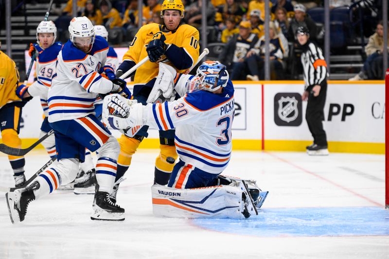 Oct 31, 2024; Nashville, Tennessee, USA;  Edmonton Oilers goaltender Calvin Pickard (30) blocks the shot of Nashville Predators center Colton Sissons (10) during the third period at Bridgestone Arena. Mandatory Credit: Steve Roberts-Imagn Images