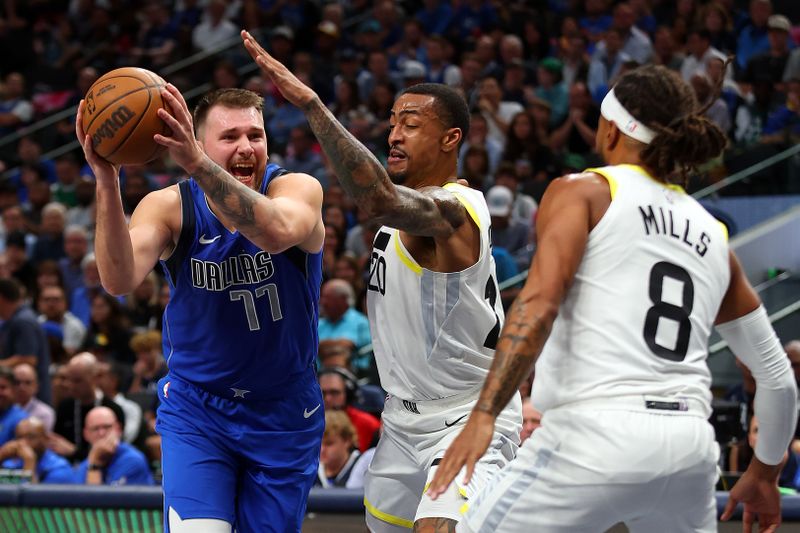 DALLAS, TEXAS - OCTOBER 28: Luka Doncic #77 of the Dallas Mavericks tries to drive past John Collins #20  and Patty Mills #8 of the Utah Jazz in the second period at American Airlines Center on October 28, 2024 in Dallas, Texas. NOTE TO USER: User expressly acknowledges and agrees that, by downloading and or using this photograph, User is consenting to the terms and conditions of the Getty Images License Agreement. (Photo by Richard Rodriguez/Getty Images)