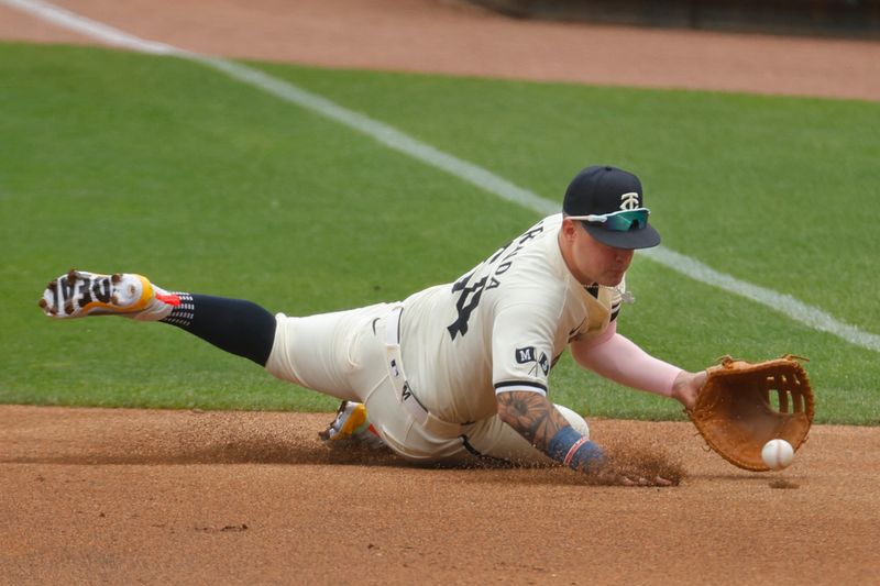 Aug 4, 2024; Minneapolis, Minnesota, USA; Minnesota Twins first baseman Jose Miranda (64) fields a ball hit by Chicago White Sox shortstop Nicky Lopez (not pictured) in the second inning at Target Field. Mandatory Credit: Bruce Kluckhohn-USA TODAY Sports