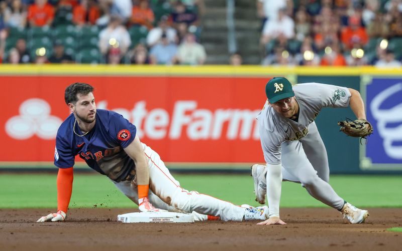 May 15, 2024; Houston, Texas, USA; Houston Astros right fielder Kyle Tucker (30) slides into second base on a double against Oakland Athletics shortstop Max Schuemann (12) in the first inning at Minute Maid Park. Mandatory Credit: Thomas Shea-USA TODAY Sports