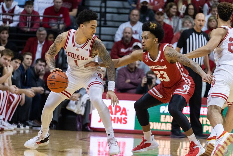 Jan 14, 2023; Bloomington, Indiana, USA; Indiana Hoosiers guard Jalen Hood-Schifino (1) dribbles the ball while Wisconsin Badgers guard Chucky Hepburn (23) defends in the second half at Simon Skjodt Assembly Hall. Mandatory Credit: Trevor Ruszkowski-USA TODAY Sports