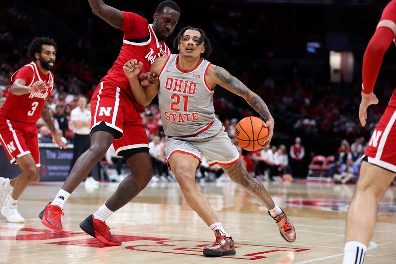 Mar 4, 2025; Columbus, Ohio, USA;  Ohio State Buckeyes forward Devin Royal (21) dribbles the ball as Nebraska Cornhuskers forward Juwan Gary (4) defends during the second half at Value City Arena. Mandatory Credit: Joseph Maiorana-Imagn Images