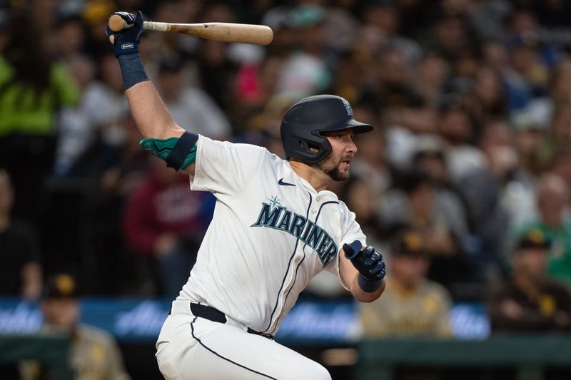 Sep 11, 2024; Seattle, Washington, USA;  Seattle Mariners catcher Cal Raleigh (29) hits a RBI-single during the third inning against the San Diego Padres at T-Mobile Park. Mandatory Credit: Stephen Brashear-Imagn Images