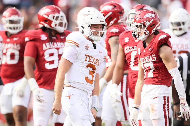 Nov 16, 2024; Fayetteville, Arkansas, USA; Texas Longhorns quarterback Quinn Ewers (3) celebrates after making a final first down to end the game against the Arkansas Razorbacks at Donald W. Reynolds Razorback Stadium. Texas won 20-10. Mandatory Credit: Nelson Chenault-Imagn Images