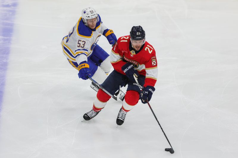 Feb 27, 2024; Sunrise, Florida, USA; Florida Panthers center Nick Cousins (21) moves the puck past Buffalo Sabres left wing Jeff Skinner (53) during the first period at Amerant Bank Arena. Mandatory Credit: Sam Navarro-USA TODAY Sports