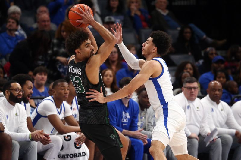 Feb 11, 2024; Memphis, Tennessee, USA; Tulane Green Wave guard Tre' Williams (13) handle the ball as Memphis Tigers guard Jahvon Quinerly (11) defends during the first half at FedExForum. Mandatory Credit: Petre Thomas-USA TODAY Sports