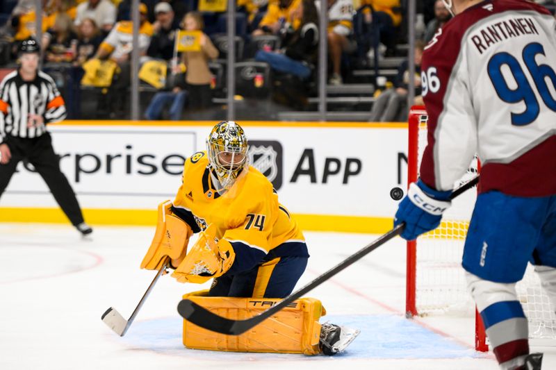 Nov 2, 2024; Nashville, Tennessee, USA;  Colorado Avalanche defenseman Cale Makar (8) scores past Nashville Predators goaltender Juuse Saros (74) during the second period at Bridgestone Arena. Mandatory Credit: Steve Roberts-Imagn Images
