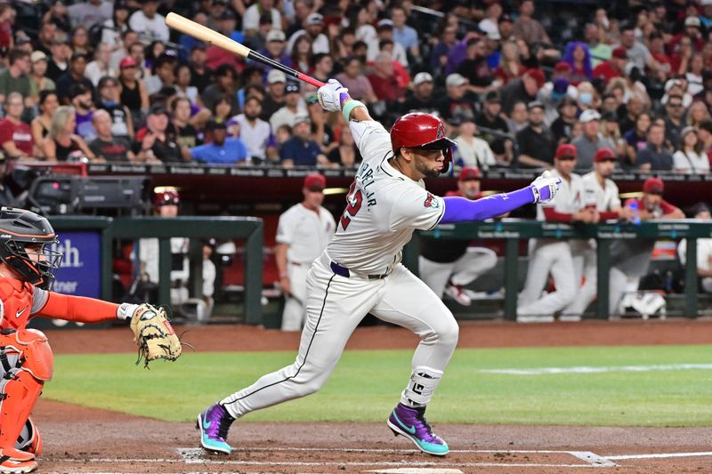 Sep 25, 2024; Phoenix, Arizona, USA; Arizona Diamondbacks outfielder Lourdes Gurriel Jr. (12) hits an RBI single in the second inning against the San Francisco Giants at Chase Field. Mandatory Credit: Matt Kartozian-Imagn Images